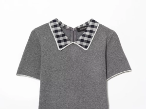 Close-up of grey knit dress featuring a black and white plaid Peter Pan collar detail