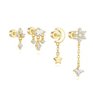 Macro detail of gold S925 silver star moon and flower earrings with zircon insets