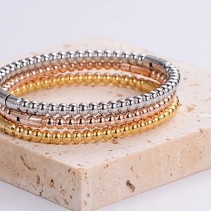 Three-piece stainless steel ball buckle bracelets in gold, silver, and rose gold finish