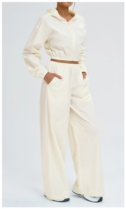 Close-up of cream-white two-piece sports set featuring hooded zipper jacket and pants