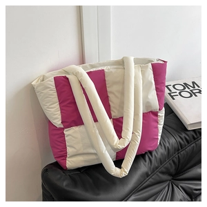 Detail of quilted tote bag featuring pink and cream checkerboard pattern and soft texture