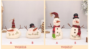Detail view of snowman figurines with plaid hats and carrot noses for Christmas decor