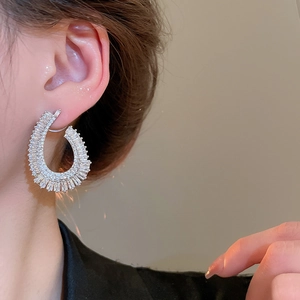 Detail of silver drop earrings with zircons shown on model for elegant styling