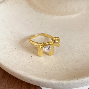Macro shot of gold horse-shaped open ring featuring a sparkling heart zircon stone