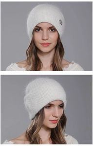 Detailed view of white angora knit beanie featuring a sparkling silver crystal flower brooch