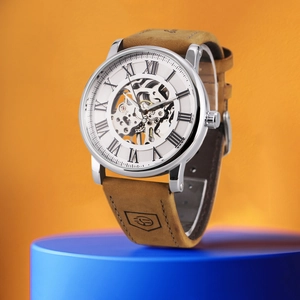 Macro detail of skeleton mechanical watch with silver case and brown leather strap