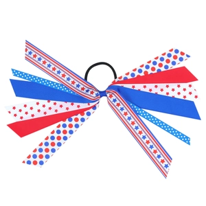 Close-up of patriotic American flag bow hair tie with red blue and white ribbons