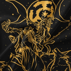 Detail of bohemian tapestry fabric showing golden moon and star patterns on black textile
