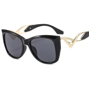 Chic butterfly cat-eye sunglasses for women with black frame and golden cutout temples