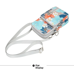 Detail view of tropical floral crossbody phone bag with three zip pockets and heart pulls