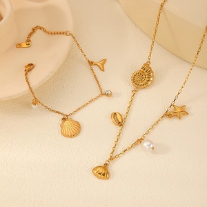 Golden ocean themed necklace and bracelet set with starfish and shell charms
