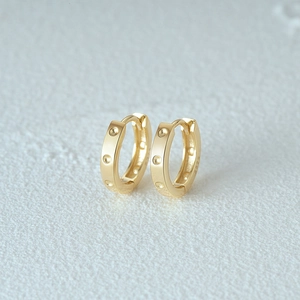 Macro view of S925 sterling silver gold-plated square hoop earrings showing S925 hallmark