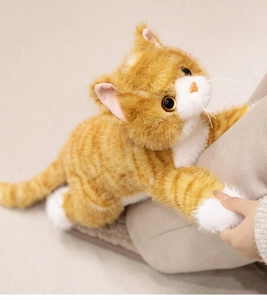 Close-up of orange tabby plush cat with realistic fur texture and soft white paws
