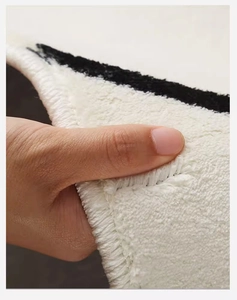 Close-up of thick plush cashmere-like texture and durable edge stitching on pumpkin mat