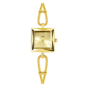 Macro shot of square champagne dial and decorative gold woven chain strap watch