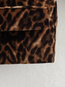 Close-up of the textured leopard print fabric and stitching detail on the blazer