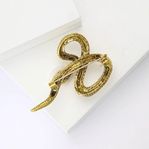 Detailed back view of golden snake brooch showing the pin mechanism and metal texture