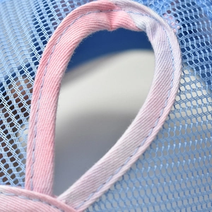 Close-up of blue mesh sun hat featuring breathable texture and purple ponytail hole stitching