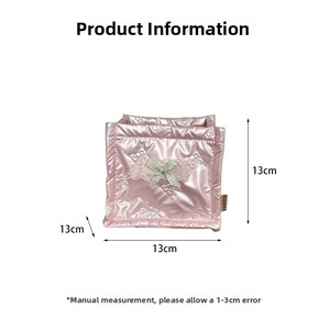 Close-up of pink quilted square storage box with green bow and 13cm size details