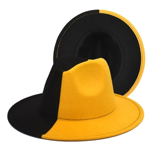 Detailed view of two-tone yellow and black wool fedora with wide brim and stitched edge