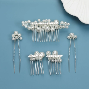 Five-piece bridal hair accessory set with baroque pearls and silver combs on blue surface
