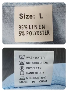Detail view of clothing care label showing 95% linen material and washing instructions