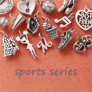 Collection of vintage silver sports series charms including soccer ball and engraved pendants