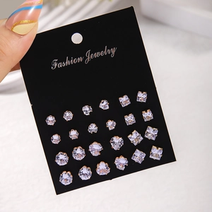Close-up of 12 pairs of gold zircon stud earrings in round heart and square shapes