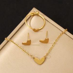 Detail view of heart-shaped gold stainless steel jewelry set in a silk gift box