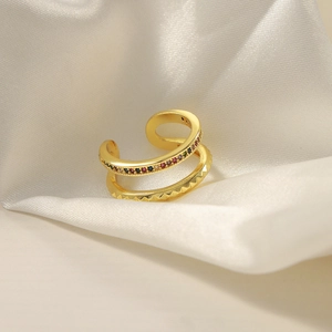 Double-layer gold ear cuff with colorful gemstones and geometric patterns on white silk