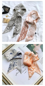 Detail of vintage alphabet silk twilly scarves with mythology prints on a magazine