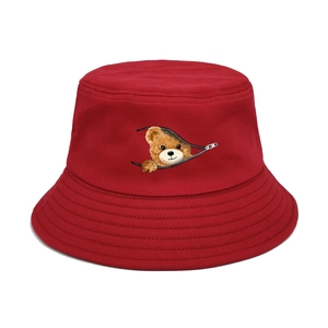 Close-up of red cotton bucket hat featuring a creative bear zipper graphic and reinforced brim