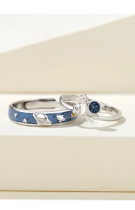 Detail of S925 sterling silver astronaut couple rings with blue enamel stars and rocket