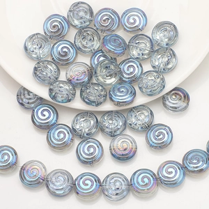 Detailed view of spiral round iridescent light blue crystal glass beads for DIY jewelry
