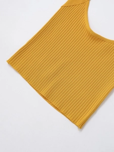 Close-up of bright yellow ribbed knit fabric texture on a halter neck crop top