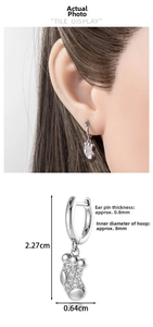 Détail de boucles d'oreilles chaussettes de Noël argentées avec zircons et mesures