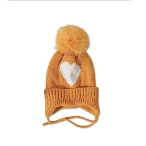 Detailed knit texture of mustard yellow baby hat with heart pattern and faux fur pompom