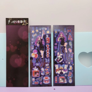 Detail of cute purple anime girl stickers and black packaging with laser finish