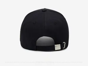 Close-up of adjustable strap with silver metal buckle on a black baseball cap