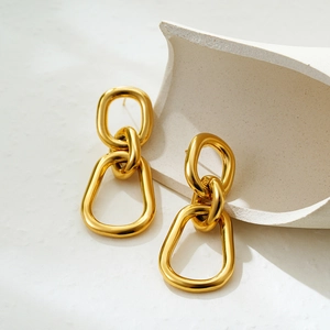 Macro view of interlocking 18K gold-plated double hoop earrings with a polished finish