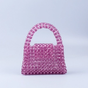 Handmade purple beaded top handle bag with geometric woven acrylic beads in trapezoid shape