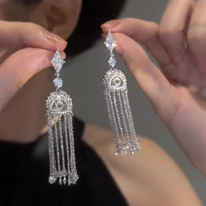 Elegant silver tassel earrings with geometric diamond-encrusted rhombic design and long chains