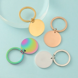Flat lay of polished circular stainless steel keychains in gold, rose gold, silver and rainbow