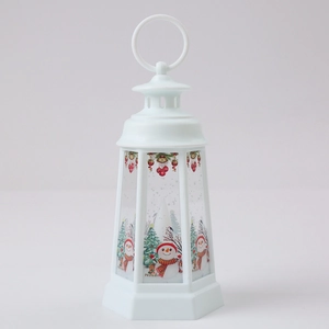 Gros plan d'une lanterne de Noël blanche avec motifs de bonhomme de neige et anneau