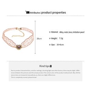 Detailed view of pink lace choker with heart resin pendant and faux pearl accents