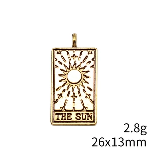 Macro detail of THE SUN golden tarot card pendant with dimensions 26x13mm and 2.8g weight