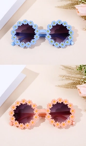 Close-up of cute daisy round flower frame sunglasses for kids in blue and pink colors