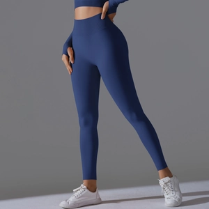 Close-up of seamless dark blue high-waisted yoga pants and long sleeve top with thumbholes