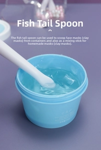Macro shot of moisturizing gel mask with white fishtail applicator spoon and blue jar