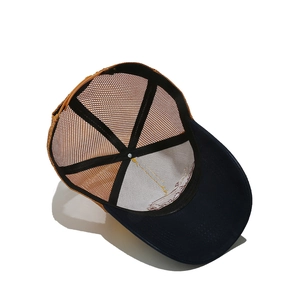 Internal structure detail of the trucker hat showing mesh panels and sturdy frame